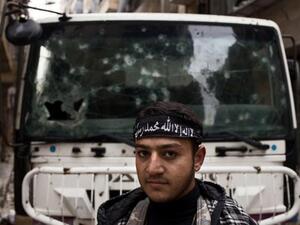 Syrian teenager Samir Qutaini, 17, poses next to a checkpoint in the Salahadine district of Aleppo on Thursday. (AFP PHOTO/STR)