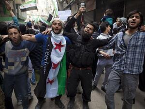 Syrian men dance and chant revolutionary slogans during the commemoration of the second anniversary of the Syrian conflict, in Bustan al-Qasr district of Aleppo. (AFP PHOTO/JM LOPEZ) Syrian men dance and chant revolutionary slogans during the commemoration of the second anniversary of the Syrian conflict, in Bustan al-Qasr district of Aleppo. (AFP PHOTO/JM LOPEZ)