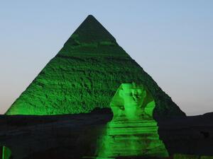A picture shows one of the three Giza Pyramids and the Sphinx (foreground) lit in green on the occasion of St. Patrick's Day. (AFP PHOTO/IRISH EMBASSY/HO) 