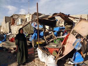 An Iraqi woman inspects the damage following a car bomb attack that happened late at night in Kirkuk, 240 kilometers north of Baghdad, on March 20, 2013, that killed one and wounded several. (AFP PHOTO / MARWAN IBRAHIM)