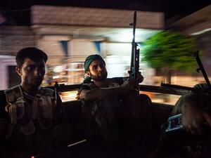 Syrian rebels head to the town of Bsankol in the northwestern province of Idlib to join comrades fighting regime forces for the control of the highway that connects Idlib with Latakia on July 11, 2013. (AFP PHOTO/DANIEL LEAL-OLIVAS)