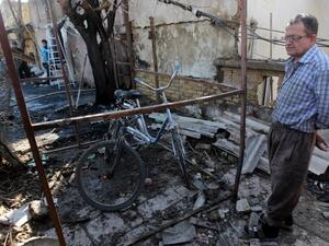 An Iraqi man inspects the site of a car bomb explosion in the Taubchi neighbourhood of the capital Baghdad on January 19, 2014, a day after the attack. [AFP]