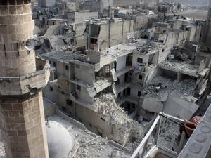 A picture taken on January 19, 2014 in the northern Syrian city of Aleppo shows buildings that fell following Government warplanes raids .[AFP]