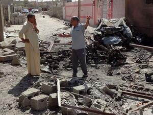 Iraqis talk on the site where a suicide bomber detonated an explosives-rigged vehicle on August 11, 2013 in the northern city of Tuz Khurmatu. Car bombs ripped through Baghdad cafes and markets while blasts and shootings struck elsewhere on August 10, killing 61 people as Iraq marked the end of its deadliest Ramadan holy month in years. (AFP)