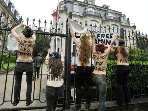 FEMEN activists protest outside the Tunisian embassy in Brussels on Thursday after three of their  bare-breasted companions get jailed in Tunis.