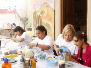 Artists at work: Ange (second from left) and fellow artists engrossed in their creations
