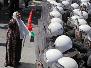Palestinian police with riot gear stand guard as they stop supporters of the Popular Front for the Liberation of Palestine (PFLP) from reaching the headquarters of president Mahmoud Abbas. (AFP).
