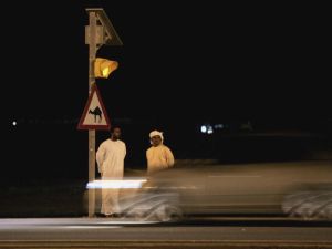 Two men wait to cross the road in a country where red lights are routinely ignored (Getty)