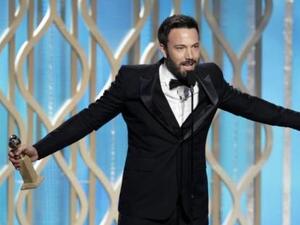 Ben Affleck picks up his Globe with pride.