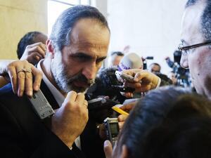 The recently resigned head of Syrian’s opposition National Coalition demanded that the leader of Hezbollah withdraw his fighters from Syria, warning of a “plot” to drag the Muslim world into long-term Sunni-Shia strife.