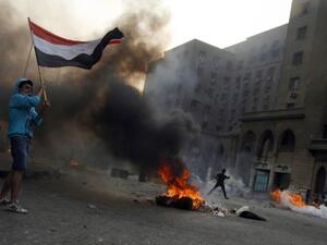 Tires burn as Egyptian Muslim brotherhood and supporters of ousted president Mohamed Morsi take part in clashes with riot police along Ramsis street in downtown Cairo, on October 6, 2013 (AFP)