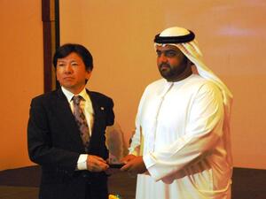 Takumi Kakara, Marketing Director of Bridgestone collecting the award