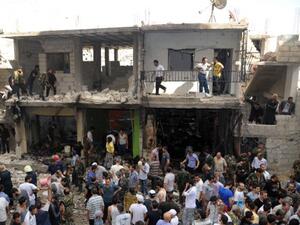 Civilians and security at the scene of a bombing in the Mezze 86 area of Damascus (AFP/SANA)