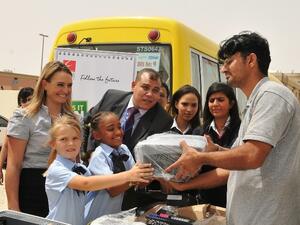 Eros Group and GEMS distributing electronic items to students