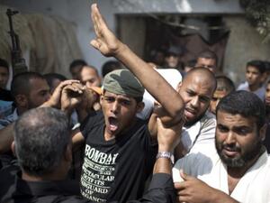 Mourners carry the body of Palestinian Huweshil Abu Huweshil, from his house to the mosque during his funeral procession south of Gaza City. (AFP)