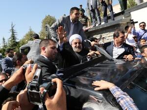 Iranian president Hassan Rouhani waves to supporters as his motorcade leaves Tehran's Mehrabad Airport upon his arrival from New York, on September 28, 2013. (AFP)