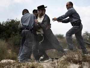  An Ultra-Orthodox Jewish man is arrested by Israeli policemen in Ramat Beit Shemesh West of Jerusalem on August 12. (AFP)