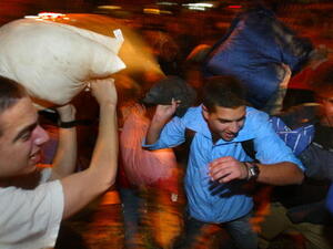 Men fighting with pillows in Israel