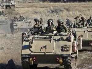 Israeli army Armored Personnel Carriers maneuver during a military exercise near the northern border with Syria on June 25, 2013. (AFP/File)