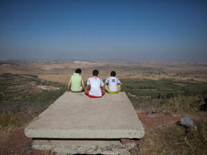 Israelis gaze at the vistas of the nearby Syrian village of Jebata al-Khashabn from an Israeli army post near the village of Buqaata at the Israeli side of the Golan border. 