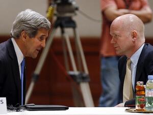 US Secretary of State John Kerry and British Foreign Secretary William Hague discuss Syria at the Friends of Syria meeting in Amman on Wednesday evening