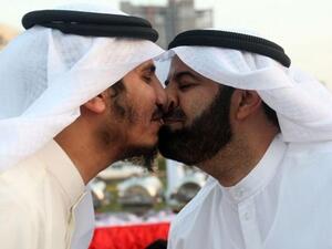 Former Kuwaiti MPs Mubarak al-Walan and Bader al-Dahoum give each other a nose kiss during a gathering in Eid al-Adha. (AFP)