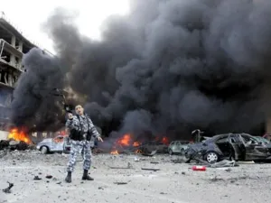 A picture taken on February 14, 2005 shows a Lebanese police officer gesturing on the site of an explosion which killed former Lebanese premier Rafiq Hariri and 21 others in Beirut. The Beirut government is in paralysis, business deals are on hold and tongues abuzz with rumours as Lebanon anxiously awaits indictments by a UN tribunal probing Hariri's murder.