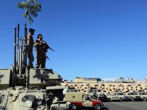 Members and vehicles of the Al-Qaaqa brigade from Zintan get ready to vacate the premises of their Tripoli quarter on November 21, 2013, as part of a government decision to remove militias from the capital. Libya's international allies on Sunday pledged to bring stability to the country. (AFP)