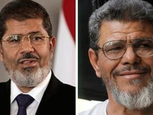 So close but yet so far: Security guards blocked a rendezvous between Egyptian President Mohamed Morsi (left) and his look-alike. 