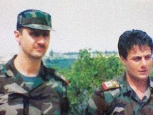 An undated photo showing a young Manaf Tlas (right) next to President Assad