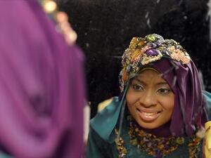 Obabiyi Aishah Ajibola, a 21-year-old contestant from Lagos, looks in the mirror shortly before winning the Miss Muslim World competition. (AFP)