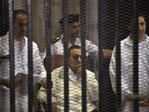 Ousted Egyptian president Hosni Mubarak (C) and his two sons Alaa (R) and Gamal (L) are seen behind the defendents' cage during their retrial at the Police Academy in Cairo on Saturday. The sons have now been released. AFP photo