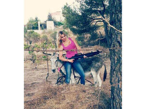 Myriam posing with her two favorite things: Guns and donkey "Fairuz." (Image: Fairuz)