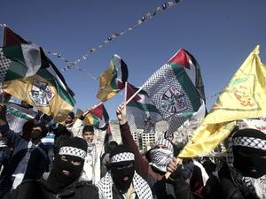 Palestinian supporters of the Palestinian leader Mahmud Abbas’ Fatah party wave flags during a rally marking the 49th anniversary of the movement on January 2, 2014 in the West Bank city of Nablus. (AFP)