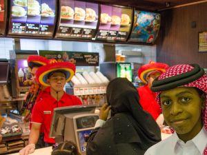 A Qatari mother and son order dinner at a McDonalds in Doha (Albawaba/J. Zach Hollo)