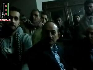 Syrian rebels appear in this YouTube video gathered around two men, one of them identified as Raqqa governor Hussein Jalali. (Al Arabiya)