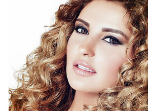 Shatha Hassoun was overly excited to be sunbathing by Julio Iglesias' side in Dubai! (Image: Facebook)