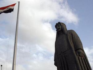 The Syrian flag flies high above a statue of Sultan Pasha al-Attrash in Swaida. (Photo: Ahram English)