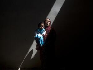 Amina, a Syrian woman who fled the fighting in Aleppo, is photographed inside an abandoned building with her five-month-old sick daughter, Asma, on the outskirts of Saraqib, southwest of Aleppo, on September 9, 2013. According to the Red Cross, more than one million Syrians are going hungry. (AFP)

