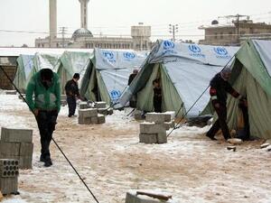 Snow covers the ground outside tents supplied by the UNHCR for Syrian refugee families in al-Marj, in the eastern Lebanese Bekaa Valley, on January 9, 2013 (AFP/File, Hassan Jarah)