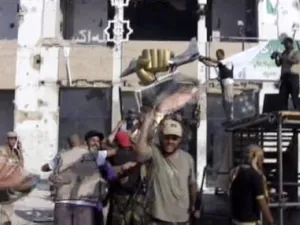 The triumphant fist of Gaddafi is now held up in rebel triumph against the falling leader believed to be hiding in the heavily fortified luxury tunnels built in the '80s. Other rebels stamped on a gold bust of the dictator's head. 
