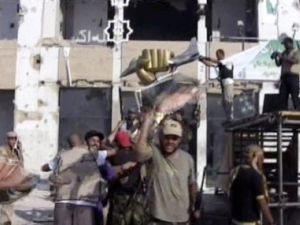 The triumphant fist of Gaddafi is now held up in rebel triumph against the falling leader believed to be hiding in the heavily fortified luxury tunnels built in the '80s. Other rebels stamped on a gold bust of the dictator's head. 