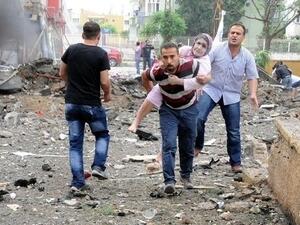 An injured woman is carried to safety after the car bomb in Reyhanli earlier this month. AFP