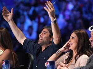 Wael and Elissa share a joke on-screen.