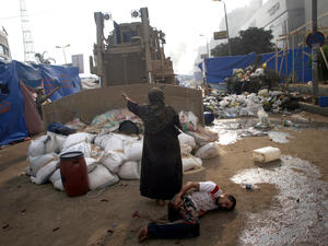 An Egyptian woman tries to stop a military bulldozer (AFP/MOHAMMED ABDEL MONEIM) An Egyptian woman tries to stop a military bulldozer (AFP/MOHAMMED ABDEL MONEIM)