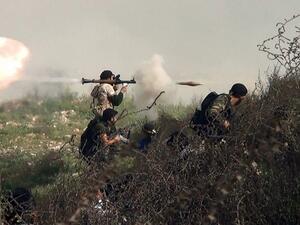 An image grab taken from a video shows an opposition fighter firing an rocket propelled grenade (RPG) on August 26, 2013 during clashes with regime forces over the strategic supply routes in and out of Aleppo. (AFP)