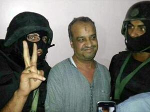 A picture distributed by the Egyptian Interior Ministry on August 29, 2013, shows senior Muslim Brotherhood politician Mohammed al-Beltagi (C) standing between two hooded policemen after his arrest in Cairo. (AFP)