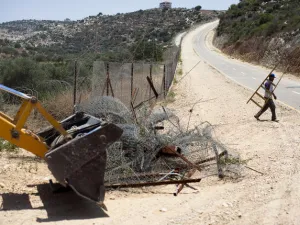 Israeli bulldozers usually seen by Palestinians on the 'wrong' side of the fence. This time, they're starting to break down the right barriers. Some say it's not enough to pull down just 'some' of the Wall dividing Palestine.
