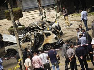 gyptians gather at the site of a bomb that targeted the convoy of the Egyptian Interior Minister Mohammed Ibrahim in Cairo on September 5, 2013. (AFP)