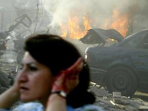 A woman holds her ears while fleeing one of the many car bomb atacks that have targeted Middle East countries over the past year (AFP)